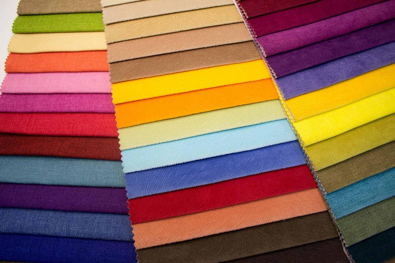 Rolls of colourful fabric in the warehouse